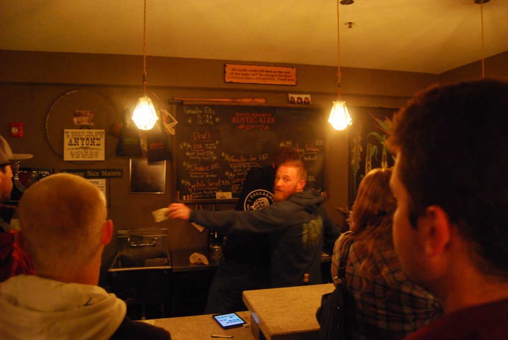 The tap list, with Jay hard at work in the foreground.