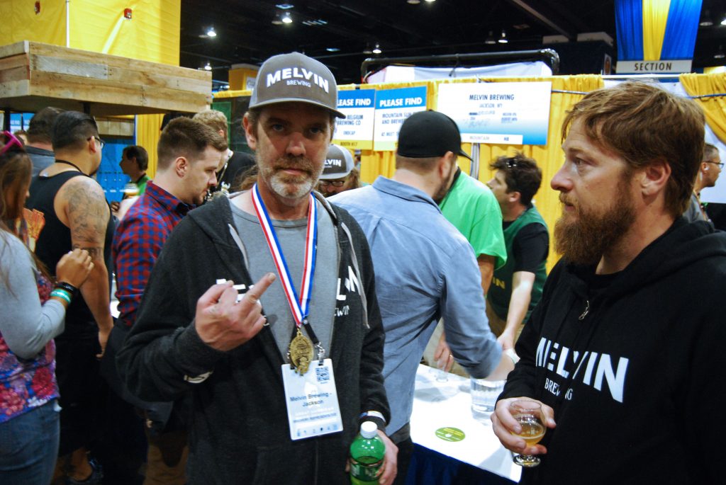 Head Brewer Kirk McHale with his GABF gold medal for Wet Hop Melvin IPA as Jeremy Tofte looks on.
